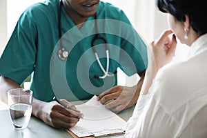 Doctor diagnose patient symptoms at the hospital photo