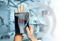 Doctor With Digital Tablet Scans Patient Hand, Modern X-Ray Technology In Medicine And Healthcare Concept