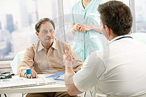 Doctor discussing diagnosis with patient photo