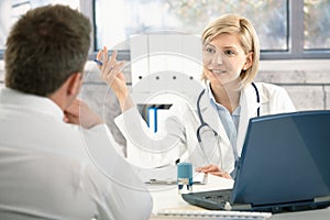 Doctor discussing diagnosis with patient photo