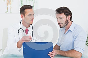 Doctor discussing reports with patient at medical office