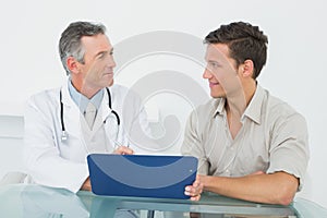 Doctor discussing reports with patient in office