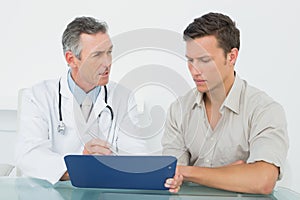 Doctor discussing reports with patient at office