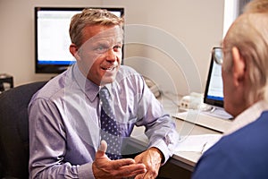 Doctor Discussing Test Results With Senior Male Patient