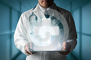 Doctor displays medical cross symbol from tablet.