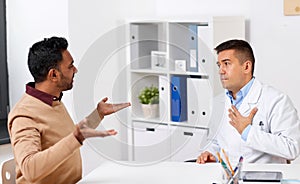 Doctor and displeased male patient argue at clinic