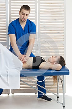 The doctor does diagnostics of muscles of an abdominal cavity of the patient. Removal of tension of muscles of a stomach