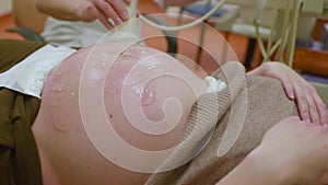 the doctor does an ultrasound examination of the fetus of a pregnant woman in a modern clinic.