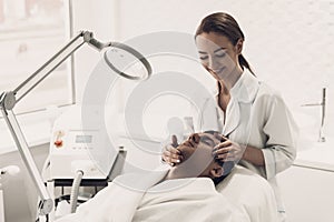 Doctor Doing Dermatology Procedure in Clinic. photo