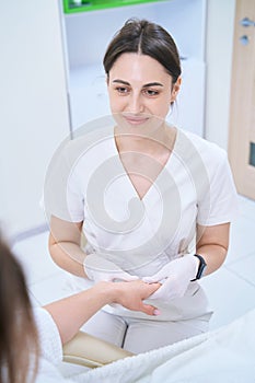 Doctor doing hand massage to a patient photo