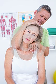 Doctor doing neck adjustment