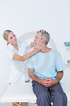 Doctor doing neck adjustment