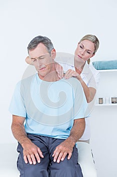 Doctor doing neck adjustment