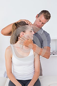 Doctor doing neck adjustment