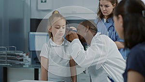 Doctor doing otology examination with otoscope to see ear infection