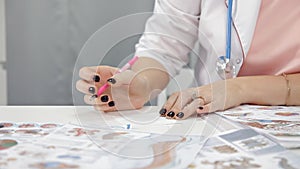 Doctor doing paperwork in her office.Portrait of nurse writing prescription