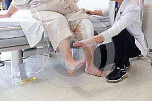 Doctor doing Physical therapy for Patient with a knee injury