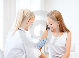 Doctor doing vaccine to child in hospital