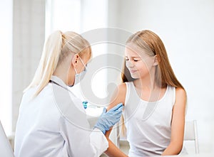 Doctor doing vaccine to child in hospital