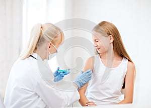 Doctor doing vaccine to child in hospital