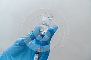 Doctor draws coronavirus vaccine into a syringe