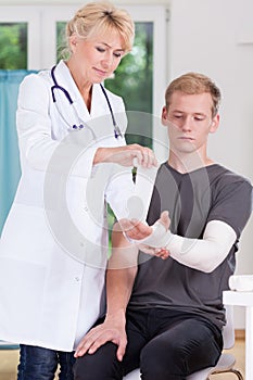 Doctor dressing upper limb