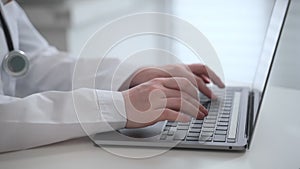 Doctor ehealth online service internist writes on laptop 