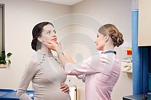 Doctor endocrinologist checking thyroid pregnant