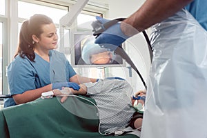 Doctor during endoscopy checking picture of mouth on screen