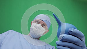 A doctor with an enema in his hands stands above the patient.