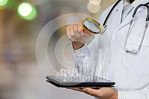 Doctor examine statistics using a magnifying glass