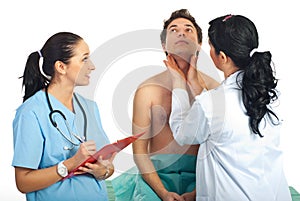 Doctor examine thyroid male patient photo