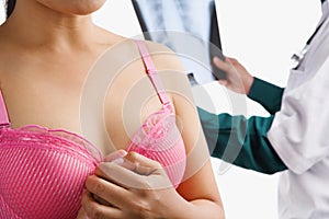 Doctor examine xray with woman on pink bra
