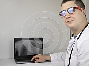 A doctor examines a chest x-ray on computer monitor. Diagnosis of respiratory diseases