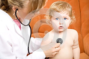 Doctor examines child using stethoscope