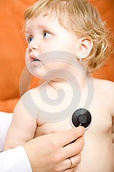 Doctor examines child using stethoscope