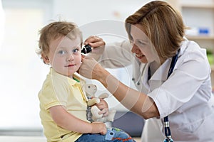 Doctor examines ear with otoscope in a pediatrician room. Medical equipment