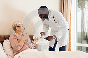 The doctor examines an elderly patient in a nursing home.