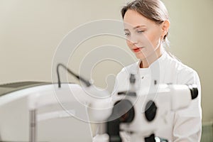 doctor examines eyes on screen of autorefractometer.