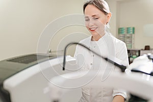 doctor examines eyes on screen of autorefractometer.