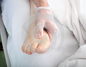 Doctor examines foot with edema photo