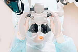 Doctor examines fundus in microscope, patient under sterile cover. Laser vision correction lasik photo