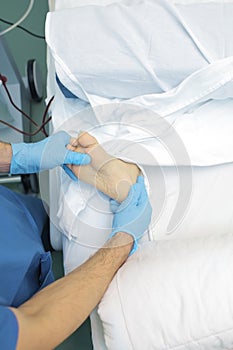 Doctor examines the patient`s foot