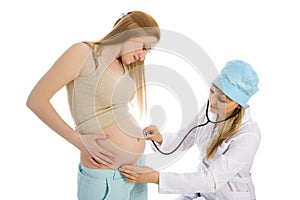 Doctor examines pregnant female using stethoscope