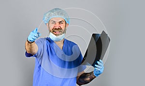 Doctor examines radiographic snapshot. Hospital emergency. Doctor uniform. X-ray concept. X ray radiation. The doctor photo