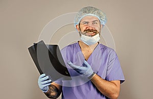 Doctor examines radiographic snapshot. Hospital emergency. Surgeon estimate damages. Doctor uniform. X-ray concept. X photo