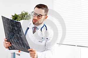 Doctor examines an x-ray in her office