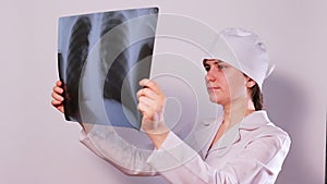 A doctor examines an X-ray of the lungs of a patient with pneumonia. Pulmonology and radiology, lung disease