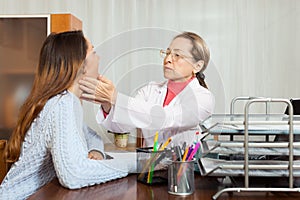 Doctor examines throat of young girl