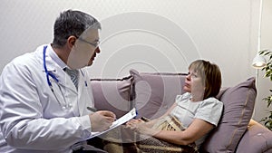 Doctor examines woman complaining of sore throat